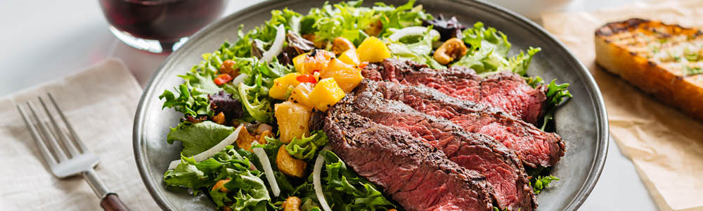 Grilled steak salad with mixed greens